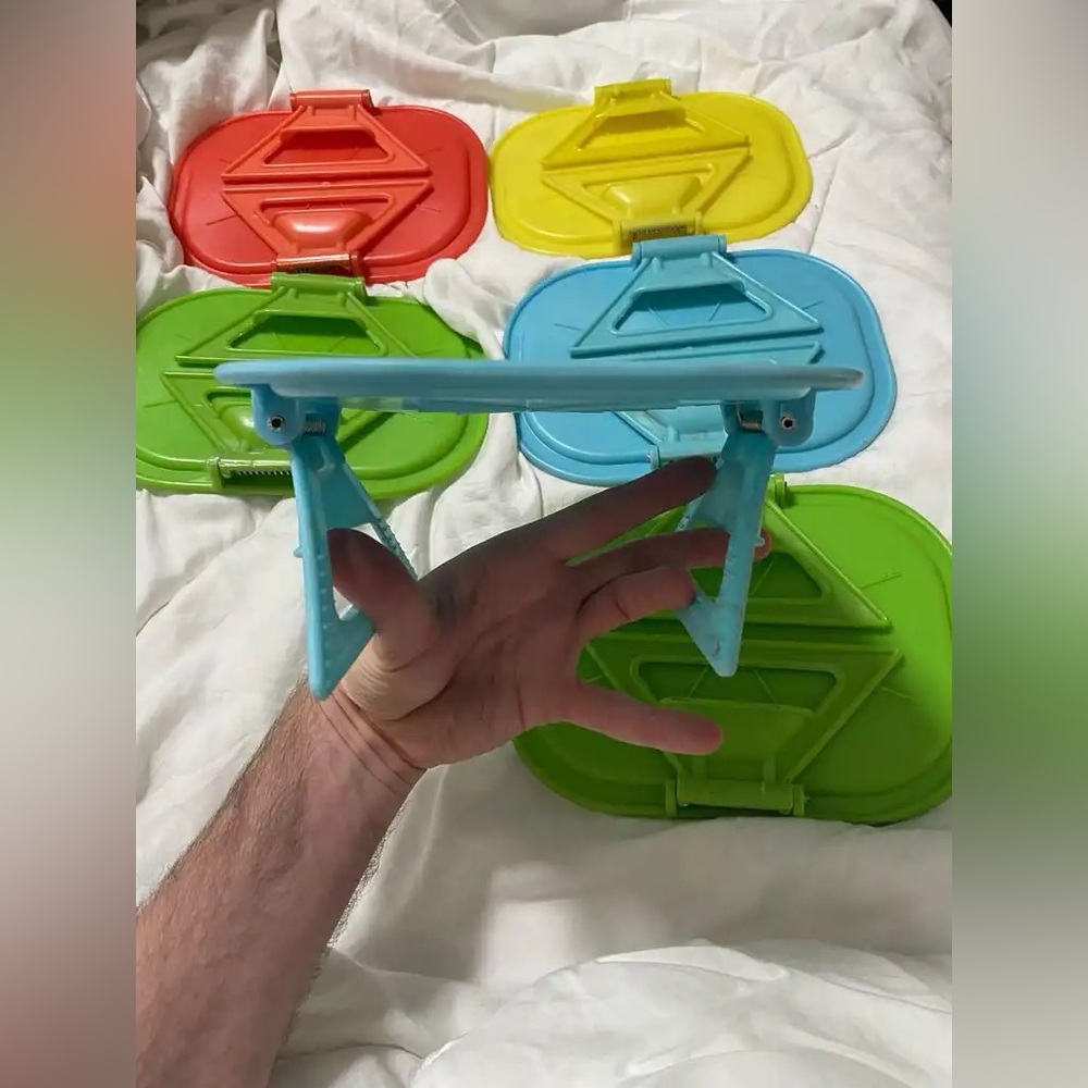 6 colorful plastic trays that clamp onto the arms of chair, recliner, couch.